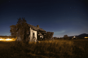 An Abandoned Wooden Barn on Grassy Terrain