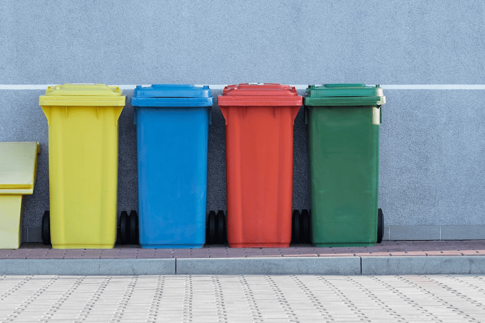 Different colored trash cans.